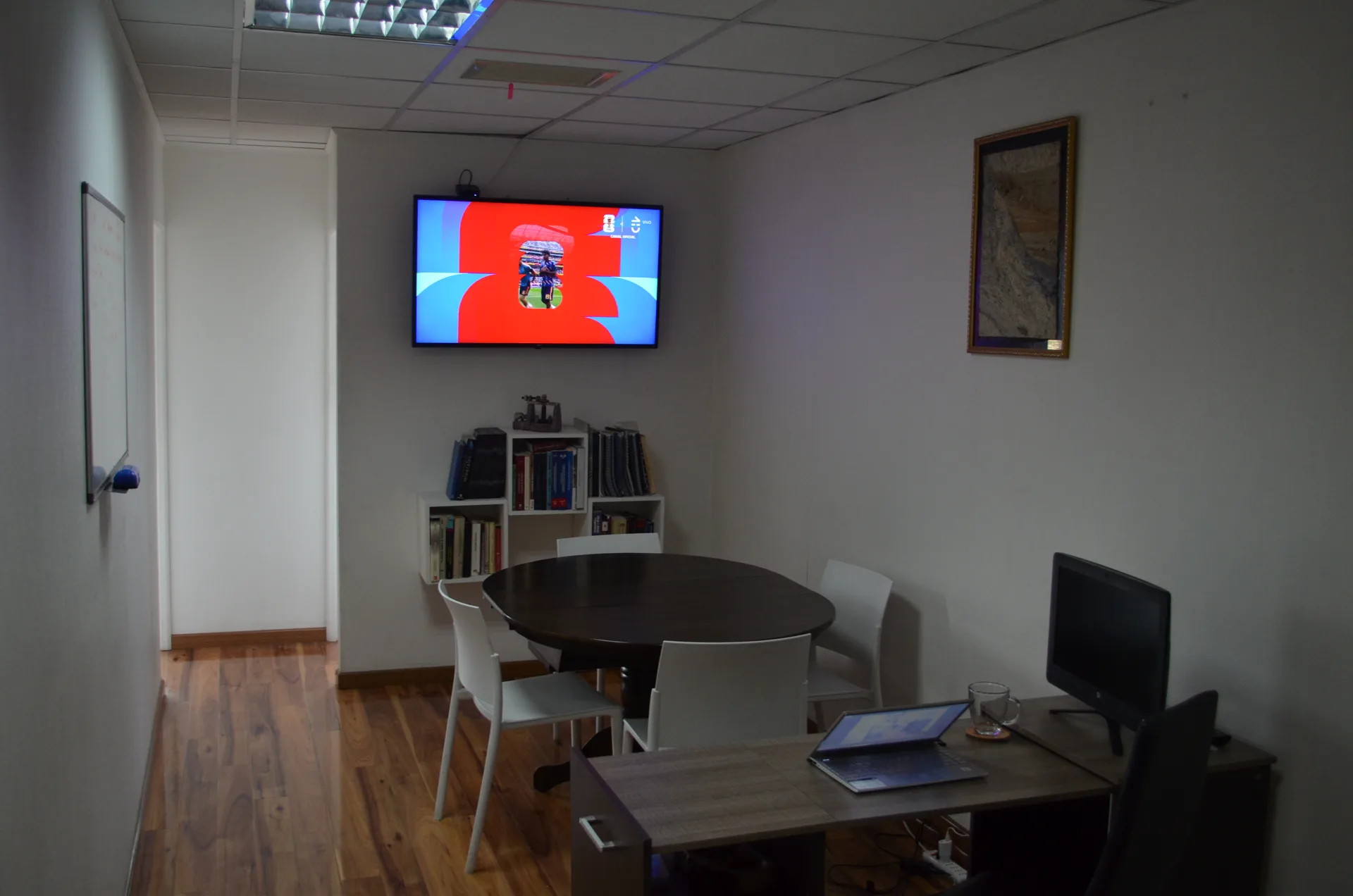 Sala de reuniones con mesa redonda y pizarra